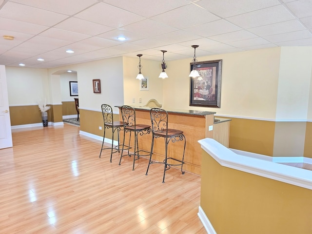 4 Forest View Dr, Hawthorn Woods, IL 60047 - indoor wet bar featuring arched walkways, light wood-style flooring, a paneled ceiling, pendant lighting, and recessed lighting