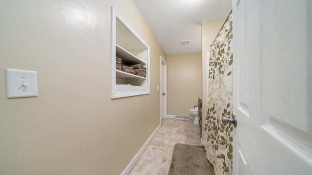 7837 Wagon Wheel Ln, Rockford, IL 61109 - hallway featuring marble finish flooring and baseboards