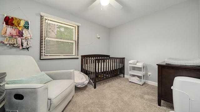 7837 Wagon Wheel Ln, Rockford, IL 61109 - bedroom with a crib, carpet floors, and a ceiling fan