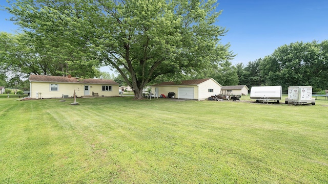 7837 Wagon Wheel Ln, Rockford, IL 61109 - view of grassy yard with a garage