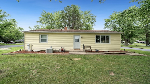 7837 Wagon Wheel Ln, Rockford, IL 61109 - rear view of house featuring a yard and a chimney