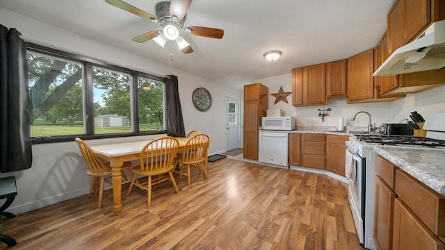 7837 Wagon Wheel Ln, Rockford, IL 61109 - kitchen featuring white appliances, under cabinet range hood, brown cabinetry, and light wood-type flooring