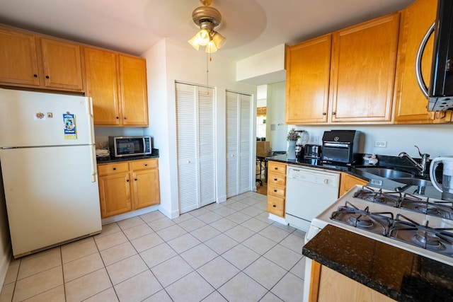 3043 N Laramie Ave Unit 2, Chicago, IL 60641 - kitchen featuring white appliances, a ceiling fan, light tile patterned floors, and dark stone countertops
