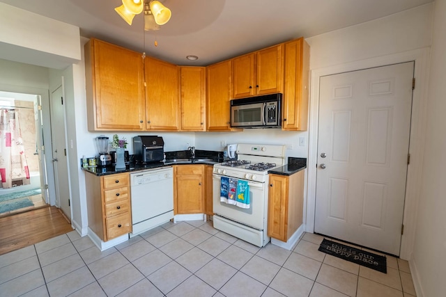 3043 N Laramie Ave Unit 2, Chicago, IL 60641 - kitchen with white appliances, light tile patterned floors, and ceiling fan