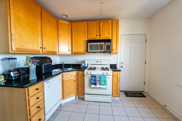 3043 N Laramie Ave Unit 2, Chicago, IL 60641 - kitchen featuring white appliances, light tile patterned floors, and dark stone countertops