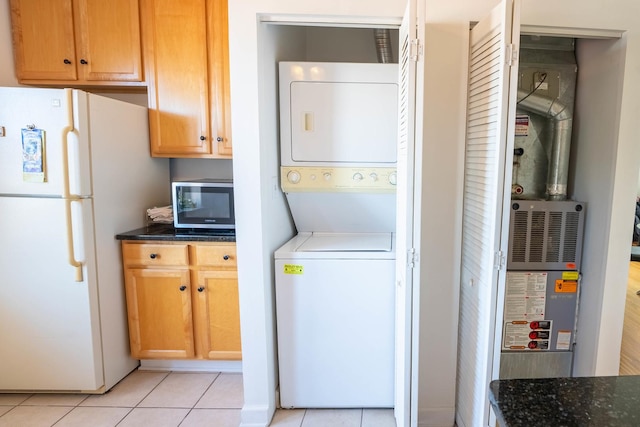 3043 N Laramie Ave Unit 2, Chicago, IL 60641 - laundry area with stacked washer and clothes dryer and light tile patterned flooring