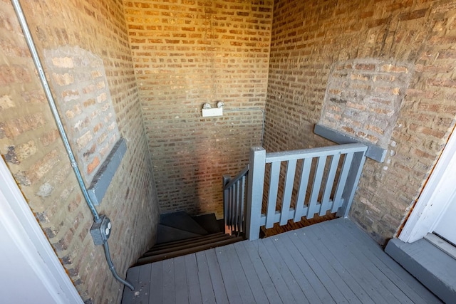 3043 N Laramie Ave Unit 2, Chicago, IL 60641 - stairway featuring wood-type flooring and brick wall