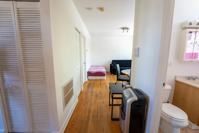 3043 N Laramie Ave Unit 2, Chicago, IL 60641 - hallway with heating unit and wood finished floors