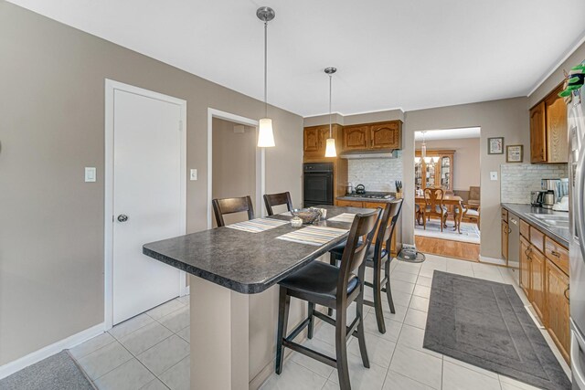 2716 Turtle Creek Dr, Hazel Crest, IL 60429 - kitchen with oven, a breakfast bar area, tasteful backsplash, and a center island