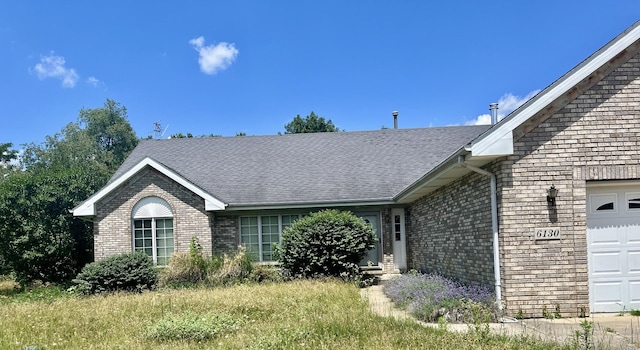 6130 N Jeffrey Ln, Oregon, IL 61061 - view of front of property with brick siding, an attached garage, and a shingled roof