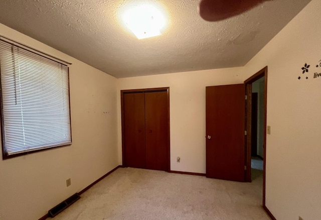 6130 N Jeffrey Ln, Oregon, IL 61061 - unfurnished bedroom with a closet, a textured ceiling, and light carpet