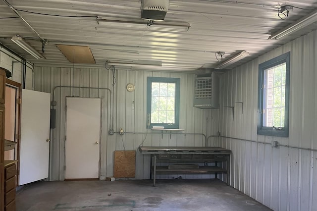 6130 N Jeffrey Ln, Oregon, IL 61061 - garage featuring a garage door opener and wood walls