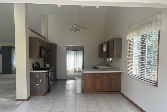 6130 N Jeffrey Ln, Oregon, IL 61061 - kitchen featuring electric stove, black microwave, light countertops, ceiling fan, and high vaulted ceiling