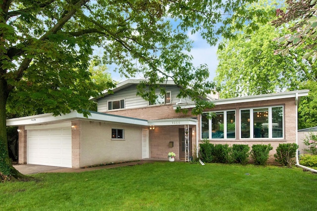 9050 Tamaroa Ter, Skokie, IL 60076 - split level home featuring a front lawn, an attached garage, and brick siding