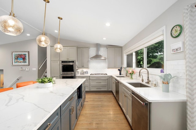 9050 Tamaroa Ter, Skokie, IL 60076 - kitchen with wall chimney range hood, gray cabinetry, stainless steel appliances, vaulted ceiling, and tasteful backsplash