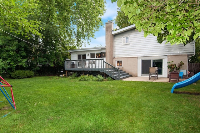 9050 Tamaroa Ter, Skokie, IL 60076 - rear view of property featuring a chimney, a deck, a yard, and brick siding