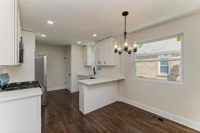 8916 S Sacramento Ave, Evergreen Park, IL 60805 - kitchen featuring white cabinetry, freestanding refrigerator, a chandelier, dark wood-style floors, and a peninsula