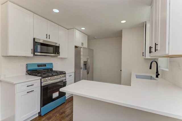 8916 S Sacramento Ave, Evergreen Park, IL 60805 - kitchen featuring stainless steel appliances, a peninsula, decorative backsplash, white cabinetry, and recessed lighting
