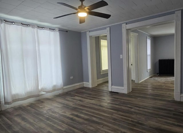 207 W Main St, La Harpe, IL 61450 - empty room with radiator heating unit, a ceiling fan, wood finished floors, and ornamental molding