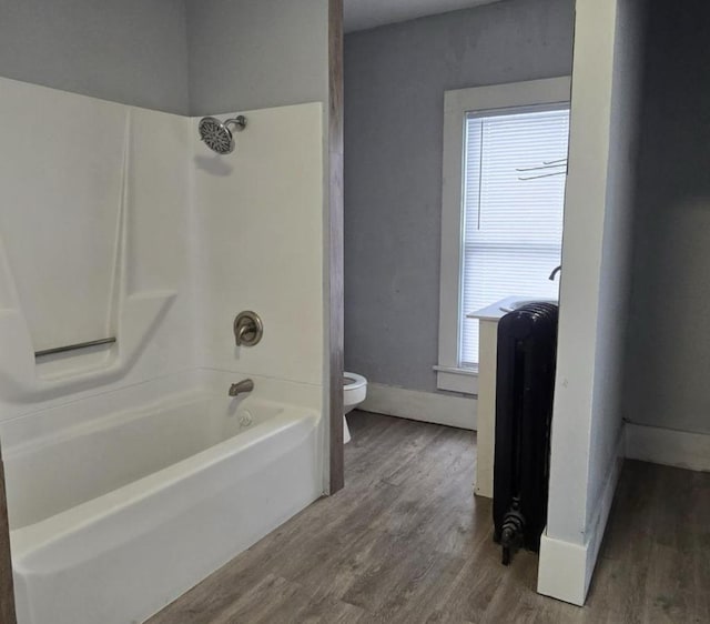 207 W Main St, La Harpe, IL 61450 - full bathroom featuring wood finished floors and tub / shower combination