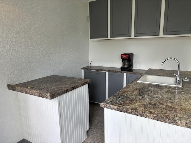 3667 Arthesia St E, Armstrong, IL 61812 - kitchen with dark countertops, a textured wall, and gray cabinetry