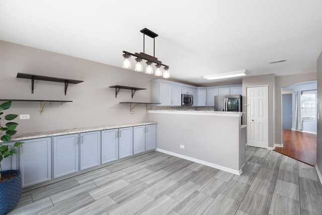 395 Cascade Ln Unit 0, Oswego, IL 60543 - kitchen featuring open shelves, stainless steel appliances, arched walkways, a peninsula, and light countertops