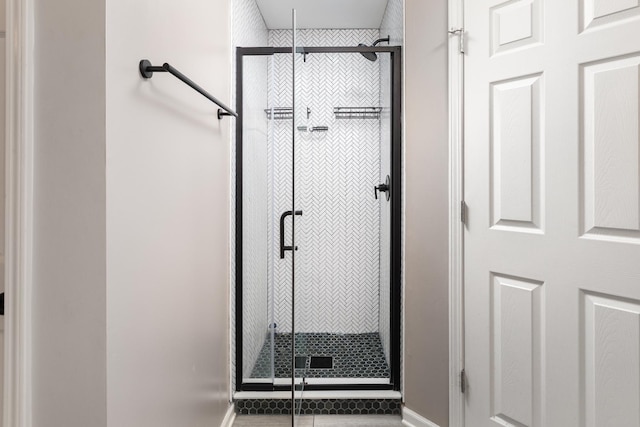 395 Cascade Ln Unit 0, Oswego, IL 60543 - bathroom featuring a stall shower and tile patterned floors
