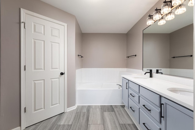 395 Cascade Ln Unit 0, Oswego, IL 60543 - full bathroom featuring double vanity, a garden tub, wood finished floors, and a chandelier