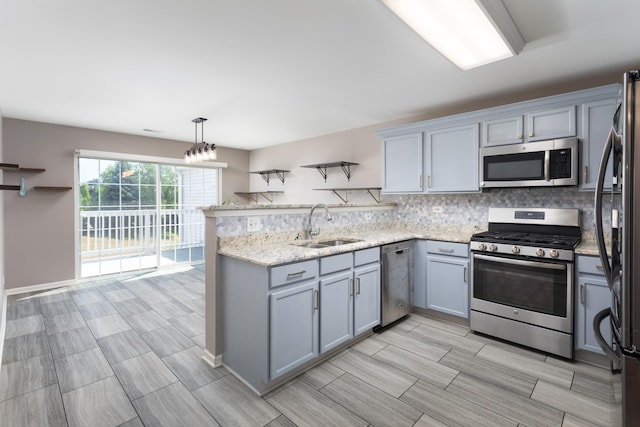 395 Cascade Ln Unit 0, Oswego, IL 60543 - kitchen with appliances with stainless steel finishes, gray cabinets, a peninsula, tasteful backsplash, and light stone counters
