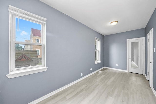 1438 S 50th Ct, Cicero, IL 60804 - unfurnished room featuring light wood-style flooring and plenty of natural light