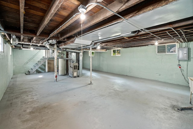 541 N May St, Aurora, IL 60506 - below grade area featuring heating unit, stairs, plenty of natural light, and electric panel