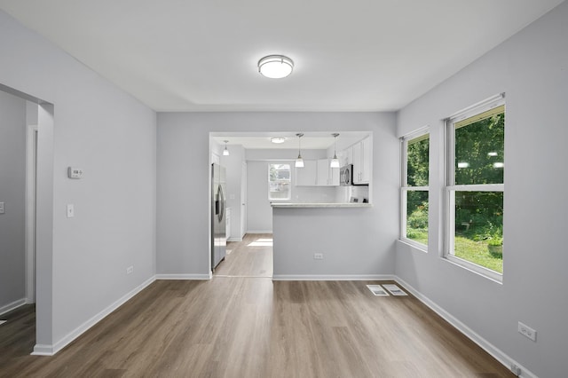 541 N May St, Aurora, IL 60506 - unfurnished living room with wood finished floors and baseboards