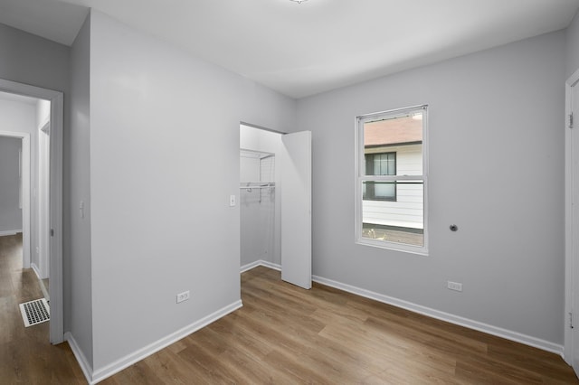 541 N May St, Aurora, IL 60506 - unfurnished bedroom with wood finished floors and a walk in closet