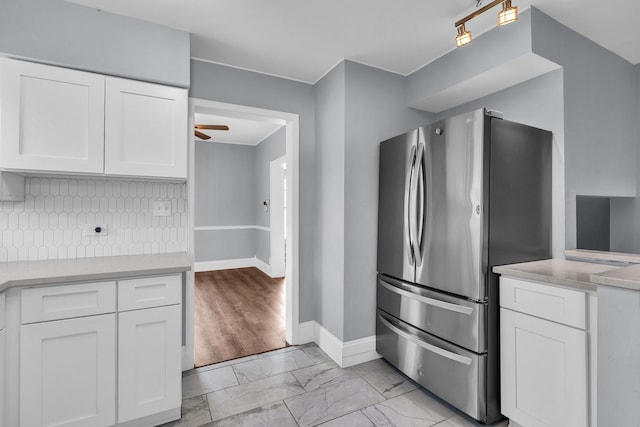 193 May St, Bensenville, IL 60106 - kitchen featuring freestanding refrigerator, light marble finish flooring, white cabinetry, and light countertops