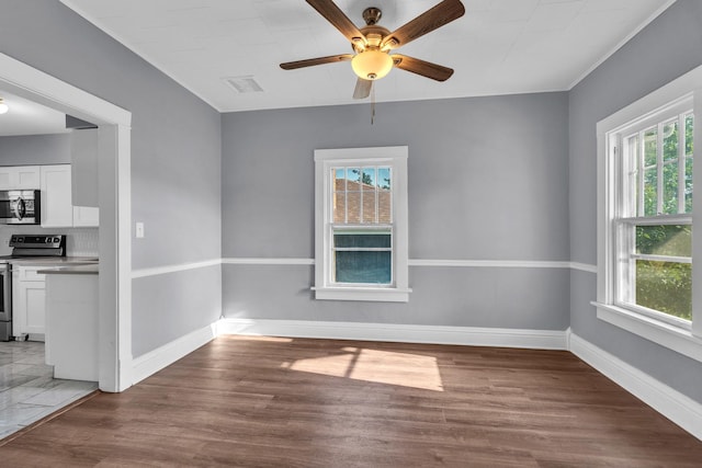 193 May St, Bensenville, IL 60106 - empty room featuring healthy amount of natural light, ceiling fan, and wood finished floors