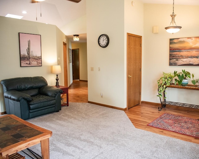 2107 10th Ave, Sterling, IL 61081 - living room featuring high vaulted ceiling, ceiling fan, carpet flooring, and wood finished floors