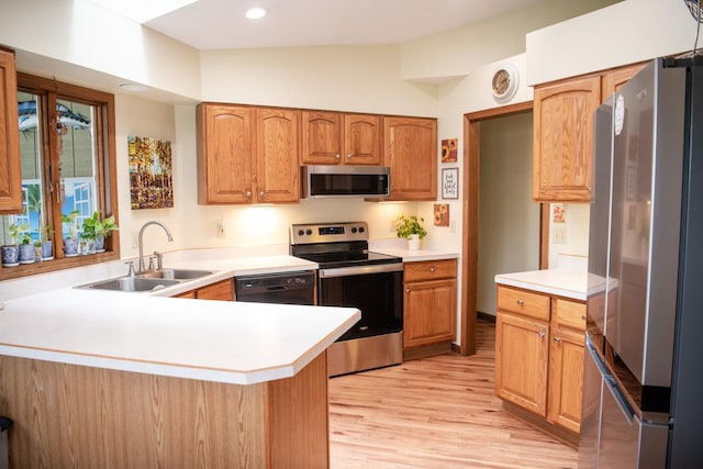 2107 10th Ave, Sterling, IL 61081 - kitchen featuring stainless steel appliances, a peninsula, light wood-style flooring, light countertops, and recessed lighting