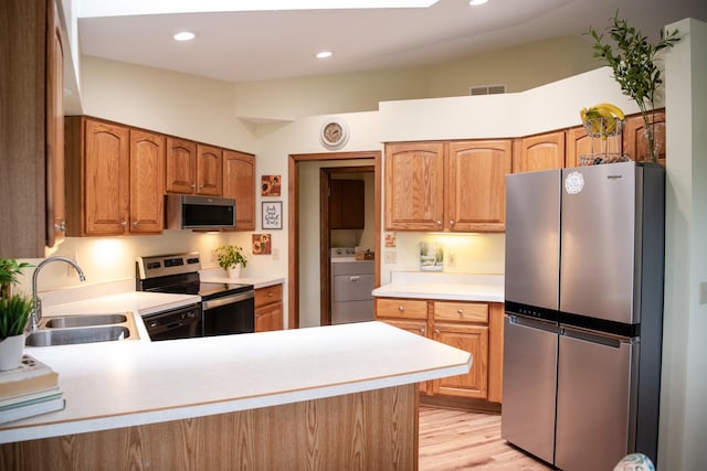 2107 10th Ave, Sterling, IL 61081 - kitchen featuring appliances with stainless steel finishes, washer / dryer, a peninsula, light countertops, and recessed lighting