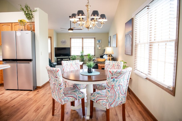 2107 10th Ave, Sterling, IL 61081 - dining room featuring light wood-type flooring, a chandelier, and lofted ceiling