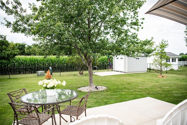 2107 10th Ave, Sterling, IL 61081 - fenced backyard featuring a patio area, a storage shed, and outdoor dining space