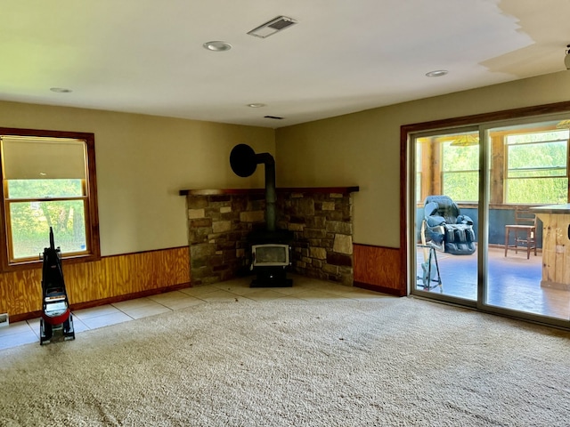 827 N 2199th Rd, Tonica, IL 61370 - living room with a wainscoted wall, healthy amount of natural light, carpet, a wood stove, and wooden walls