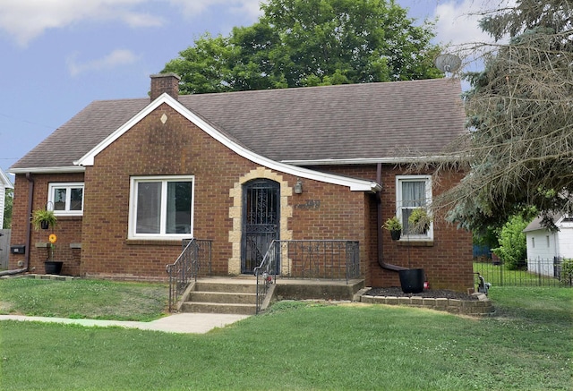 1411 E Hickory St, Streator, IL 61364 - view of front facade with brick siding, a chimney, and a shingled roof