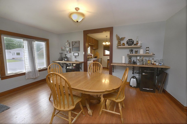 1411 E Hickory St, Streator, IL 61364 - dining room with a dry bar, light wood-style flooring, and a chandelier