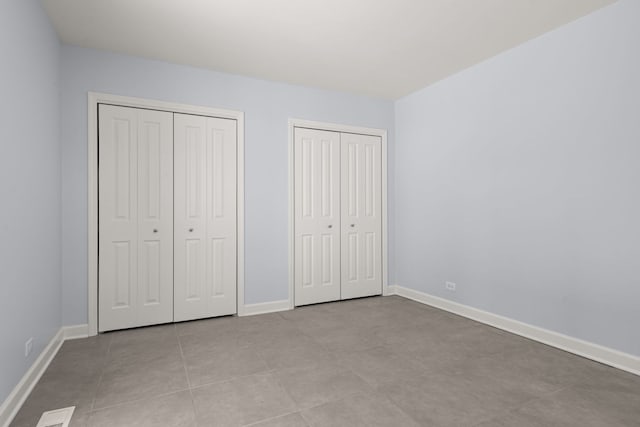 505 W Alexander Blvd, Elmhurst, IL 60126 - unfurnished bedroom featuring two closets and baseboards