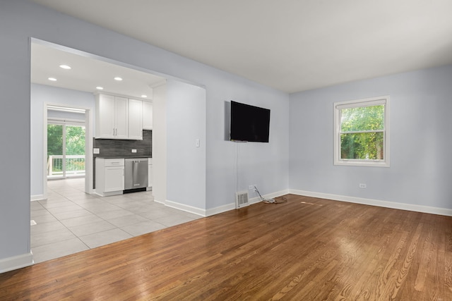 505 W Alexander Blvd, Elmhurst, IL 60126 - unfurnished living room with healthy amount of natural light, light wood-style flooring, and recessed lighting