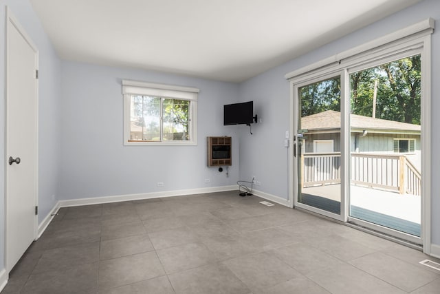 505 W Alexander Blvd, Elmhurst, IL 60126 - unfurnished living room featuring heating unit and tile patterned flooring