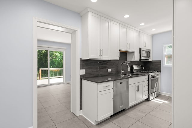 505 W Alexander Blvd, Elmhurst, IL 60126 - kitchen with stainless steel appliances, dark countertops, tasteful backsplash, light tile patterned floors, and recessed lighting
