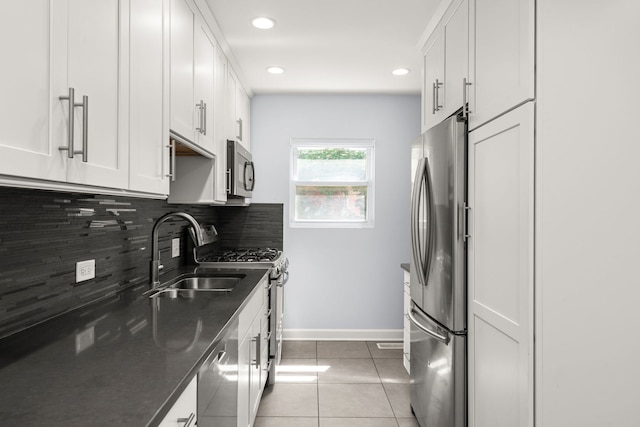 505 W Alexander Blvd, Elmhurst, IL 60126 - kitchen with stainless steel appliances, decorative backsplash, white cabinetry, light tile patterned floors, and dark stone countertops