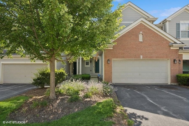 711 Creekside Cir Unit 711, Gurnee, IL 60031 - view of front facade with brick siding and asphalt driveway