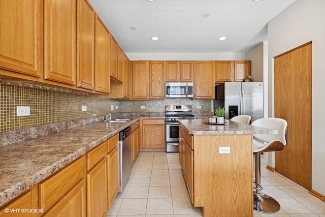 711 Creekside Cir Unit 711, Gurnee, IL 60031 - kitchen with stainless steel appliances, light tile patterned floors, a kitchen bar, a kitchen island, and backsplash